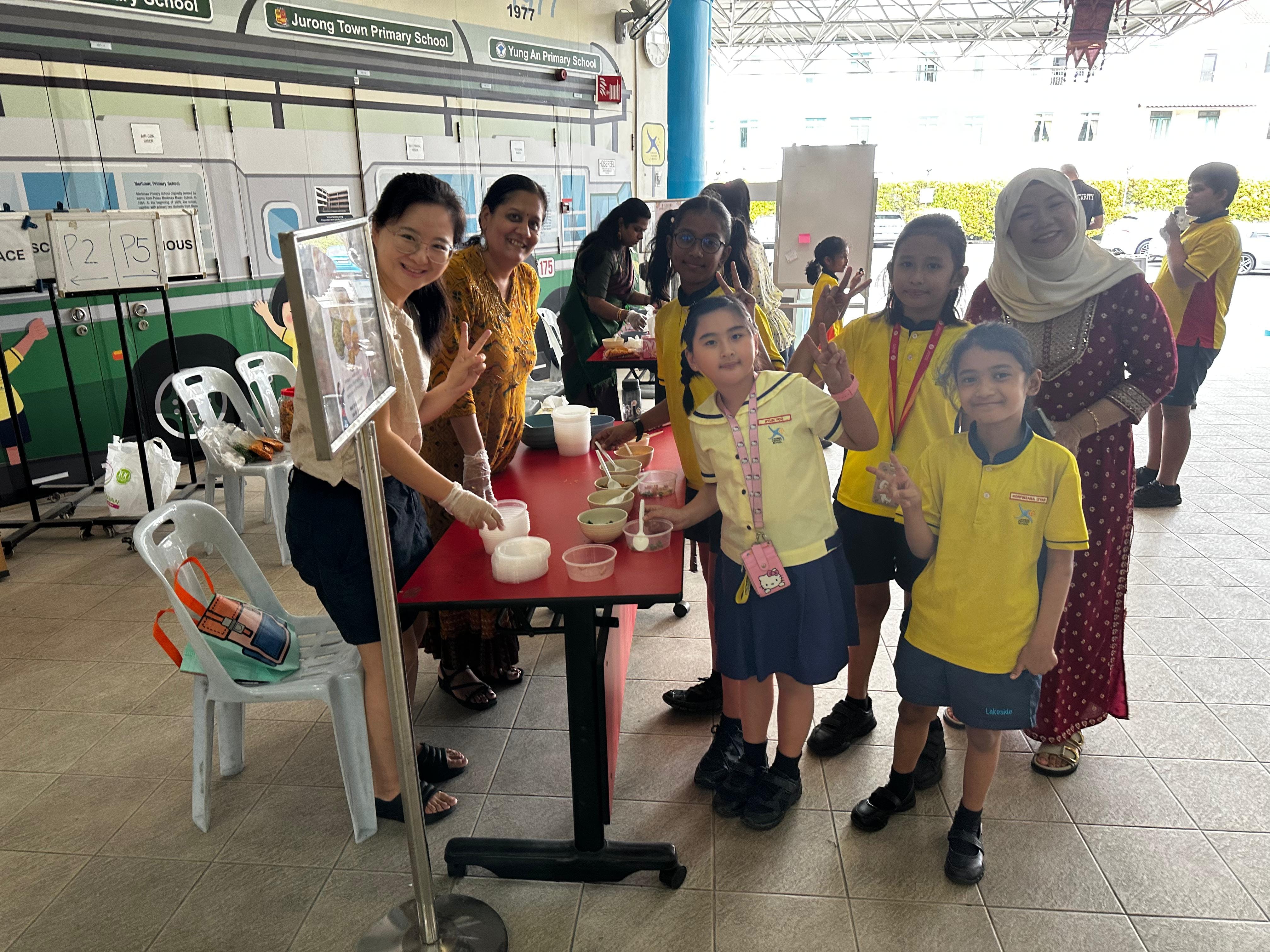 Students have fun mixing, learning and working as a team at the Mixture station, of the fun booths during recess for the celebration